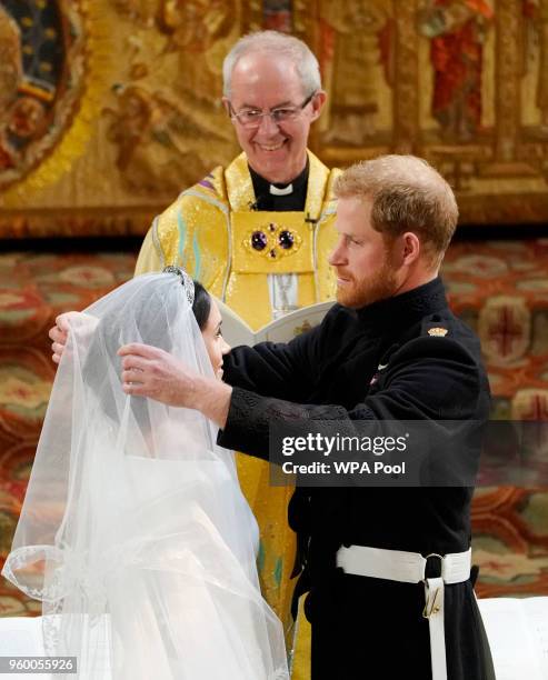 Prince Harry looks at his bride, Meghan Markle during their wedding service conducted by the Archbishop of Canterbury Justin Welby in St George's...