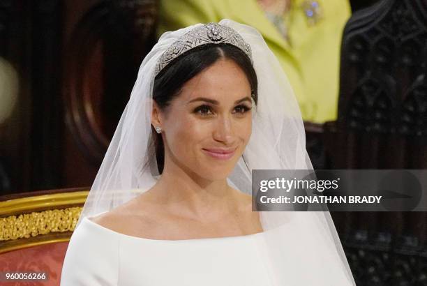 Fiancee of Britain's Prince Harry, Meghan Markle arrives at the High Altar for their wedding ceremony in St George's Chapel, Windsor Castle, in...