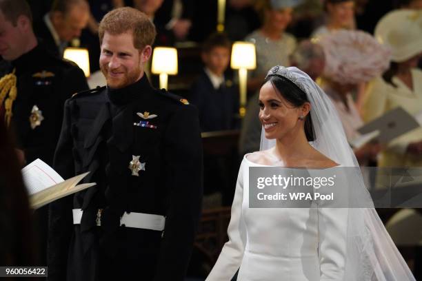 Prince Harry looks at his bride, Meghan Markle, as she arrived accompanied by Prince Charles, Prince of Wales during their wedding in St George's...