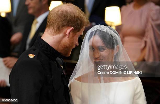 Britain's Prince Harry, Duke of Sussex and US actress Meghan Markle stand together at the altar in St George's Chapel, Windsor Castle, in Windsor, on...