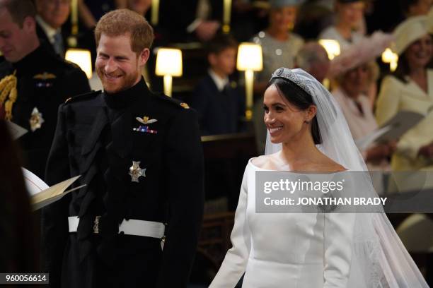 Britain's Prince Harry, Duke of Sussex, and US fiancee of Britain's Prince Harry Meghan Markle arrive at the High Altar for their wedding ceremony in...