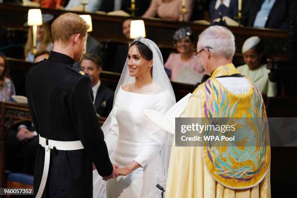 Prince Harry and Meghan Markle during their wedding service, conducted by the Archbishop of Canterbury Justin Welby in St George's Chapel at Windsor...