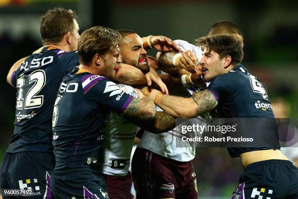 Curtis Scott of the Melbourne Storm and Dylan Walker of the Manly Sea Eagles wrestle during the round 11 NRL match between the Melbourne Storm and...