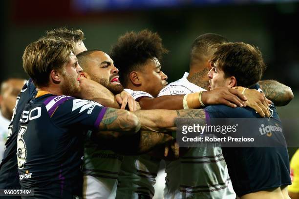 Curtis Scott of the Melbourne Storm and Dylan Walker of the Manly Sea Eagles wrestle during the round 11 NRL match between the Melbourne Storm and...