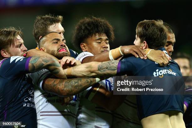 Curtis Scott of the Melbourne Storm and Dylan Walker of the Manly Sea Eagles wrestle during the round 11 NRL match between the Melbourne Storm and...