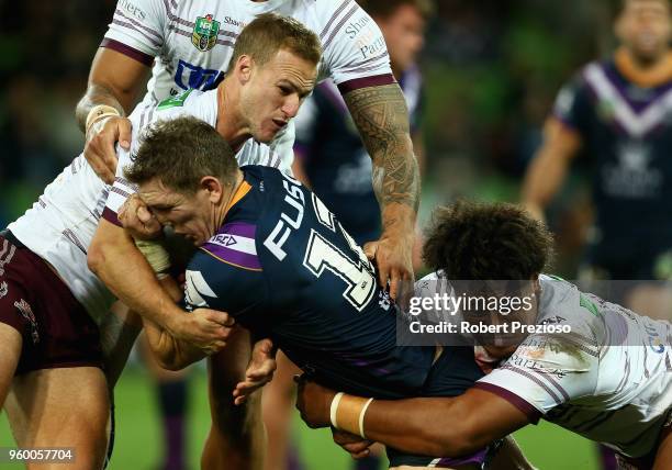 Ryan Hoffman of the Melbourne Storm is tackled during the round 11 NRL match between the Melbourne Storm and the Manly Sea Eagles at AAMI Park on May...