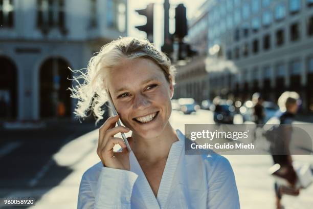 smiling businesswoman phoning in the street. - guido mieth - fotografias e filmes do acervo