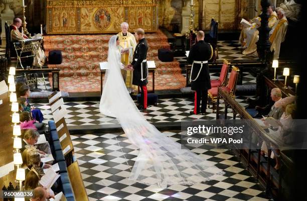 Prince Harry and Meghan Markle exchange vows during their wedding ceremony in St George's Chapel at Windsor Castle on May 19, 2018 in Windsor,...