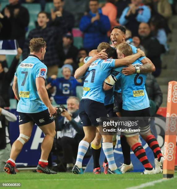 Israel Folau of the Waratahs celebrates a try with team mates during the round 14 Super Rugby match between the Waratahs and the Highlanders at...