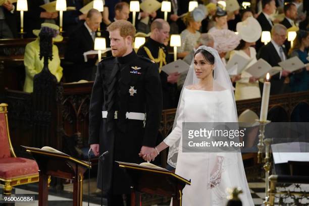 Prince Harry stands with his bride, Meghan Markle, during their wedding in St George's Chapel at Windsor Castle on May 19, 2018 in Windsor, England.