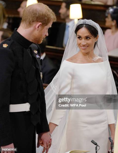 Prince Harry and Meghan Markle look at each other during their wedding service in St George's Chapel at Windsor Castle on May 19, 2018 in Windsor,...