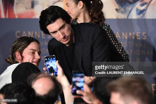 Actor Adam Driver poses for selfies on May 19, 2018 at the end of a press conference for the film "The Man Who Killed Don Quixote" at the 71st...
