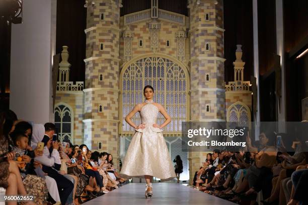 Model wears a dress from a bridal collection created by Sebastian Gunawan, an Indonesian high-fashion designer, in front of a replica of St. George's...