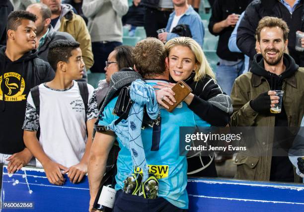 Waratahs Tom Robertson gives partner Belle Scoot a hug after they won round 14 Super Rugby match between the Waratahs and the Highlanders at Allianz...