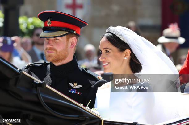 Prince Harry, Duke of Sussex and The Duchess of Sussex leave Windsor Castle in the Ascot Landau carriage during a procession after getting married at...