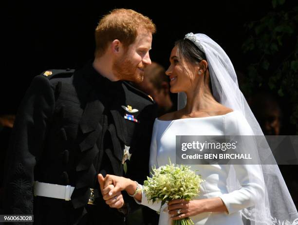 Britain's Prince Harry, Duke of Sussex and his wife Meghan, Duchess of Sussex emerge from the West Door of St George's Chapel, Windsor Castle, in...