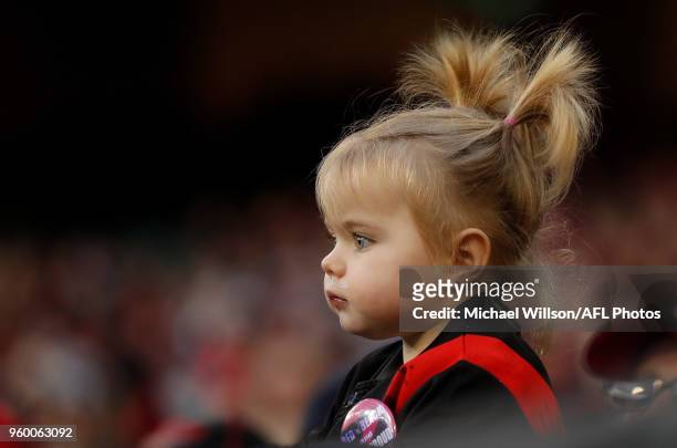Young Bombers fan looks on during the 2018 AFL round nine match between the Essendon Bombers and the Geelong Cats at the Melbourne Cricket Ground on...