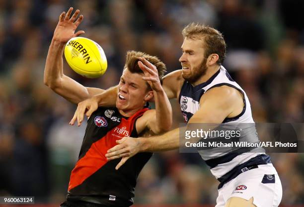 Jordan Ridley of the Bombers and Stewart Crameri of the Cats compete for the ball during the 2018 AFL round nine match between the Essendon Bombers...