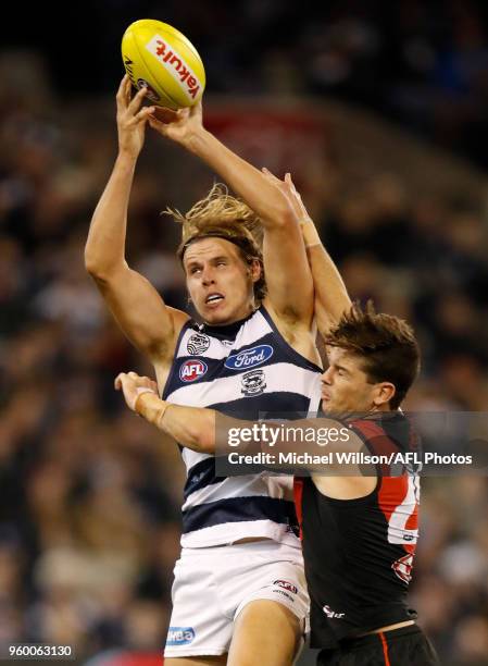 Jake Kolodjashnij of the Cats and Patrick Ambrose of the Bombers compete for the ball during the 2018 AFL round nine match between the Essendon...