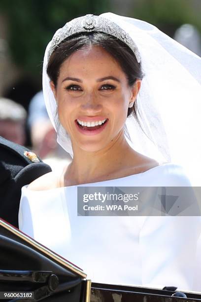 Prince Harry, Duke of Sussex and The Duchess of Sussex leave Windsor Castle in the Ascot Landau carriage during a procession after getting married at...