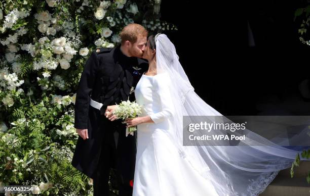 Prince Harry, Duke of Sussex and Meghan, Duchess of Sussex kiss as they leave St George's Chapel, Windsor Castle after their wedding ceremony on May...