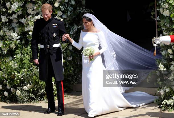 Prince Harry, Duke of Sussex and Meghan, Duchess of Sussex leave St George's Chapel, Windsor Castle after their wedding ceremony on May 19, 2018 in...