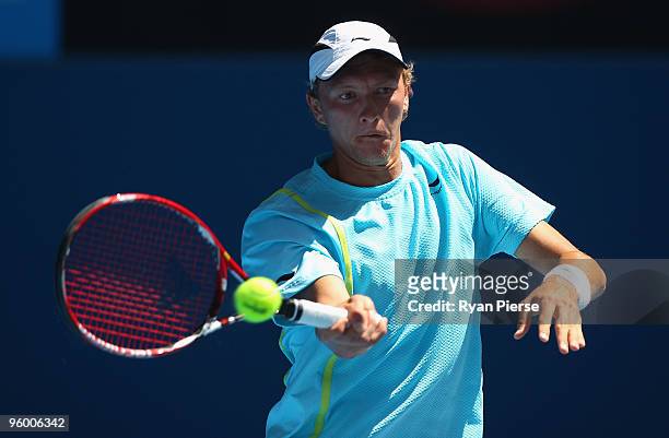 Denis Istomin of Uzbekistan plays a forehand in his third round match against Novak Djokovic of Serbia during day six of the 2010 Australian Open at...