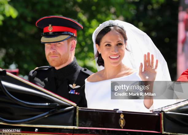 Prince Harry, Duke of Sussex and Meghan, Duchess of Sussex leave Windsor Castle in the Ascot Landau carriage during a procession after getting...