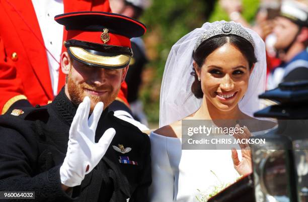 Meghan, Duchess of Sussex begins her carriage procession with Britain's Prince Harry, Duke of Sussex in the Ascot Landau Carriage after their wedding...