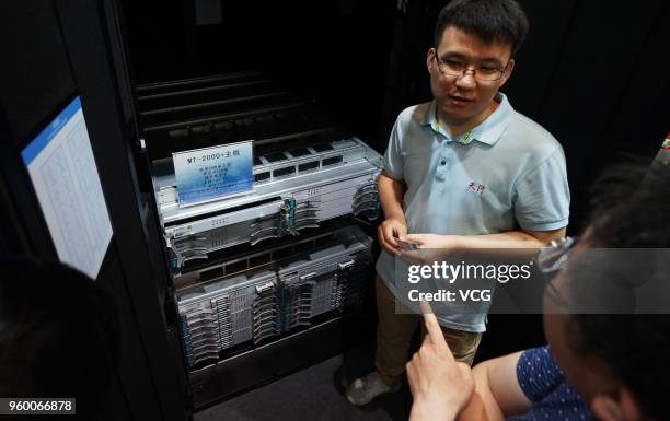 Visitors watch the motherboard of prototype of Chinese supercomputer Tianhe-3 at World Intelligence Expo as part of the 2nd World Intelligence...