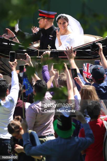 Prince Harry, Duke of Sussex and The Duchess of Sussex ride in the Ascot Landau carriage during the procession after getting married St George's...