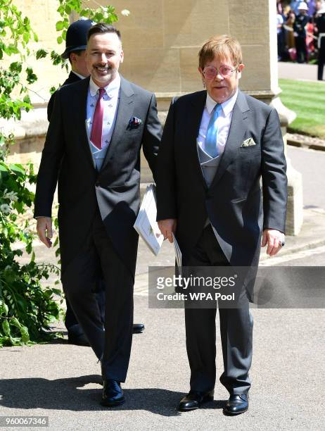 David Furnish and Sir Elton John leave St George's Chapel at Windsor Castle after the wedding of Meghan Markle and Prince Harry on May 19, 2018 in...