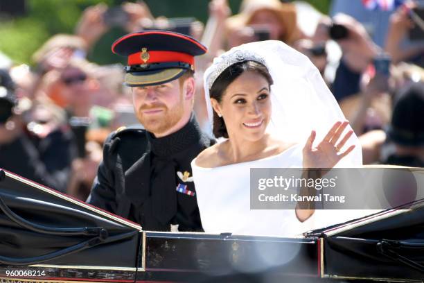 Prince Harry, Duke of Sussex and Meghan, Duchess of Sussex leave Windsor Castle in the Ascot Landau carriage during a procession after getting...