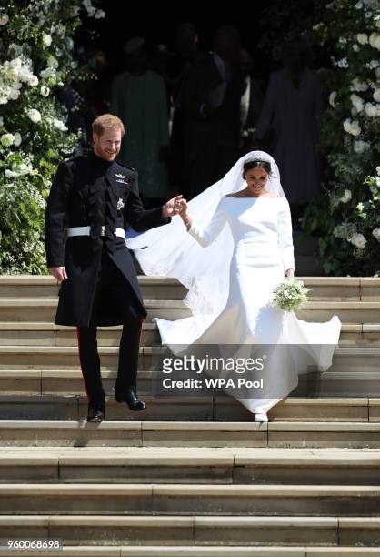 Prince Harry and Meghan Markle leave St George's Chapel after their wedding in St George's Chapel at Windsor Castle on May 19, 2018 in Windsor,...