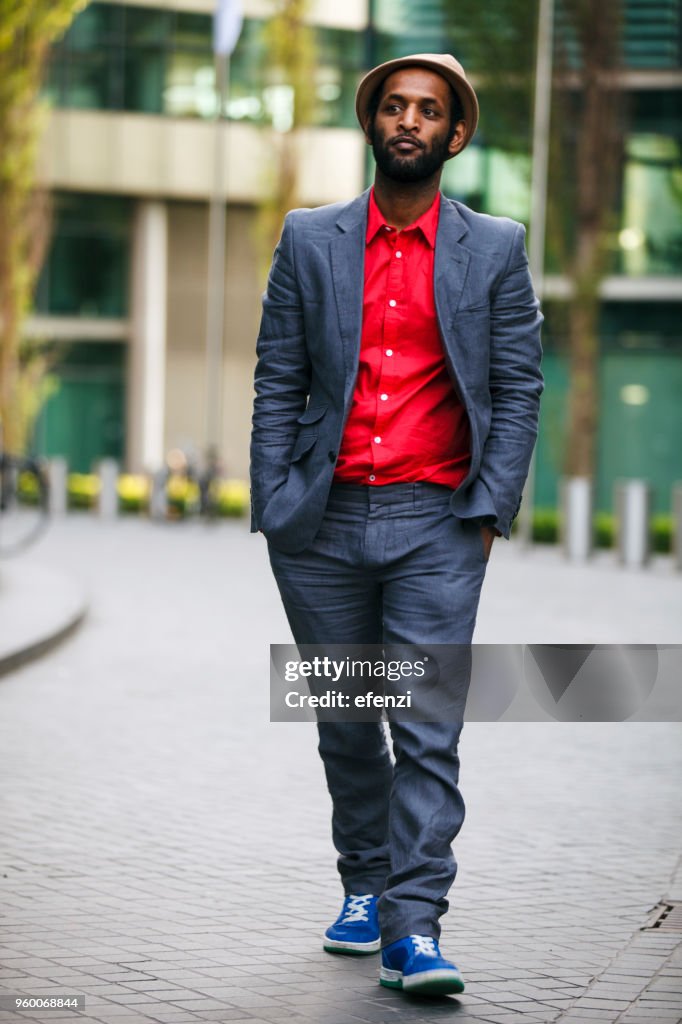 Careless Man In Suit With Hands In Pockets