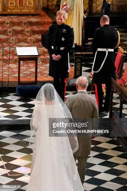 Actress Meghan Markle , accompanied by Britain's Prince Charles, Prince of Wales walks down the aisle toward her husband-to-be Britain's Prince...