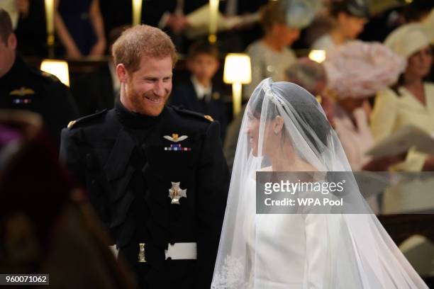 Prince Harry looks at his bride, Meghan Markle, as she arrived accompanied by Prince Charles, Prince of Wales during their wedding in St George's...