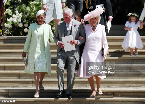 Doria Ragland, mother of the bride, Prince Charles, Prince of Wales and Camilla, Duchess of Cornwall walk down the steps at Windsor Castle after the...