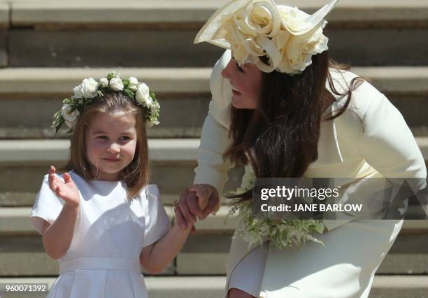 Princess Charlotte waves by her mother Britain's Catherine, Duchess of Cambridge after attending the wedding ceremony of Britain's Prince Harry, Duke...