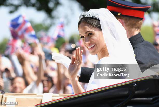 Meghan, Duchess of Sussex and Prince Harry, Duke of Sussex leave Windsor Castle in the Ascot Landau carriage during a procession after getting...