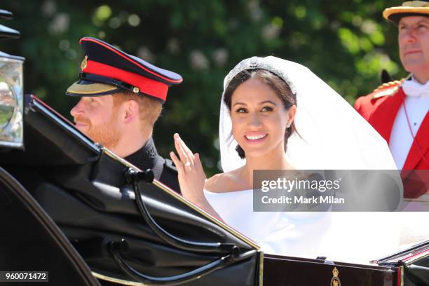 Prince Harry, Duke of Sussex and Meghan, Duchess of Sussex leave Windsor Castle in the Ascot Landau carriage during the procession after getting...