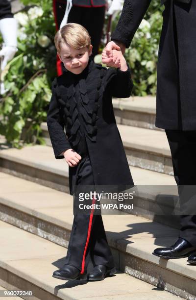 Prince George leaves St George's Chapel at Windsor Castle after the wedding of Prince Harry, Duke of Sussex and Meghan Markle on May 19, 2018 in...