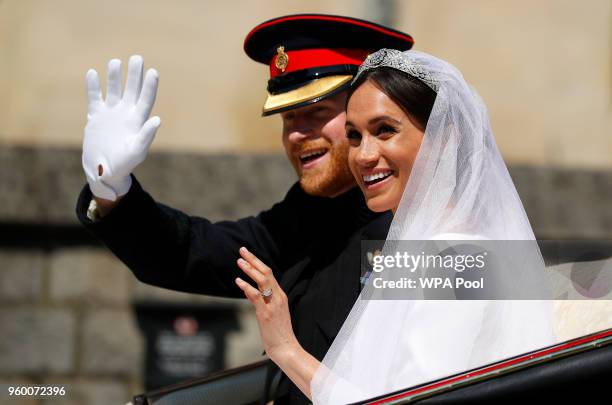 Prince Harry, Duke of Sussex and The Duchess of Sussex leave Windsor Castle in the Ascot Landau carriage during a procession after getting married at...