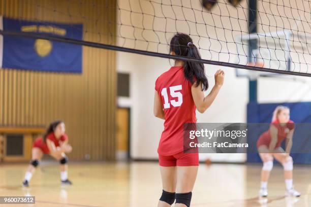 action-packed high school volleyball game - uniform stock pictures, royalty-free photos & images
