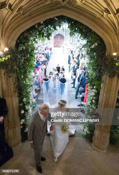 Actress Meghan Markle , accompanied by Britain's Prince Charles, Prince of Wales walks down the aisle in St George's Chapel, Windsor Castle, in...