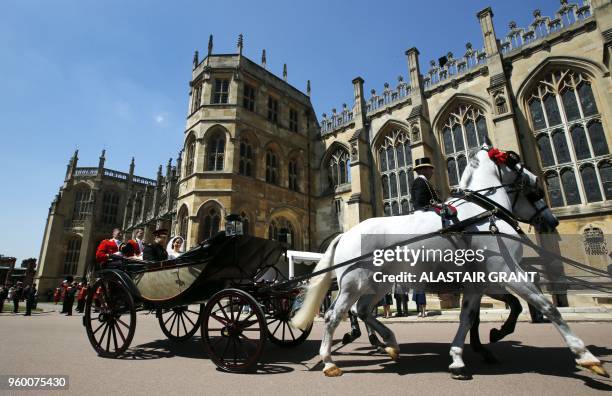 Britain's Prince Harry, Duke of Sussex and his wife Meghan, Duchess of Sussex begin their carriage procession in the Ascot Landau Carriage after...