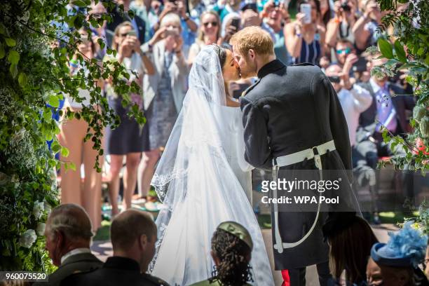 Prince Harry and Meghan Markle kiss on the steps of St George's Chapel in Windsor Castle after their wedding in St George's Chapel at Windsor Castle...