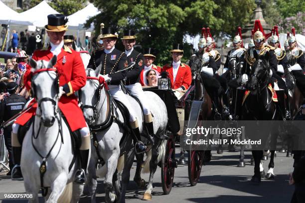 Prince Harry, Duke of Sussex and the Duchess of Sussex in the Ascot Landau carriage during the procession after getting married at St Georges Chapel...