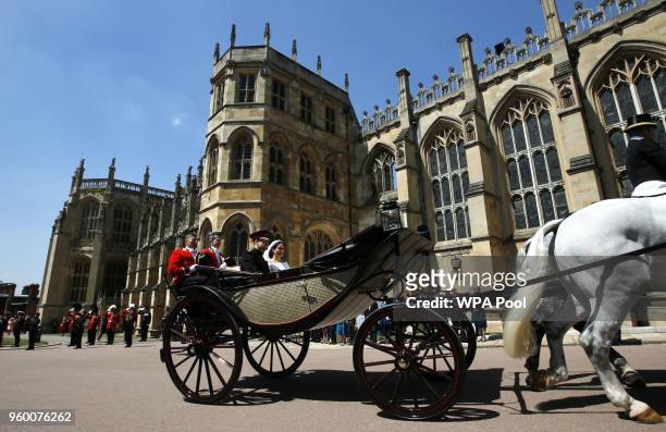 Prince Harry, Duke of Sussex and The Duchess of Sussex leave Windsor Castle in the Ascot Landau carriage during a procession after getting married at...