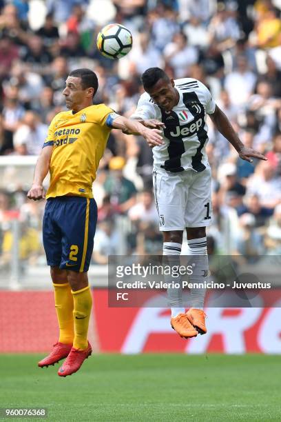 Alex Sandro of Juventus competes for the ball with Romulo Caldeira of Hellas Verona FC during the serie A match between Juventus and Hellas Verona FC...